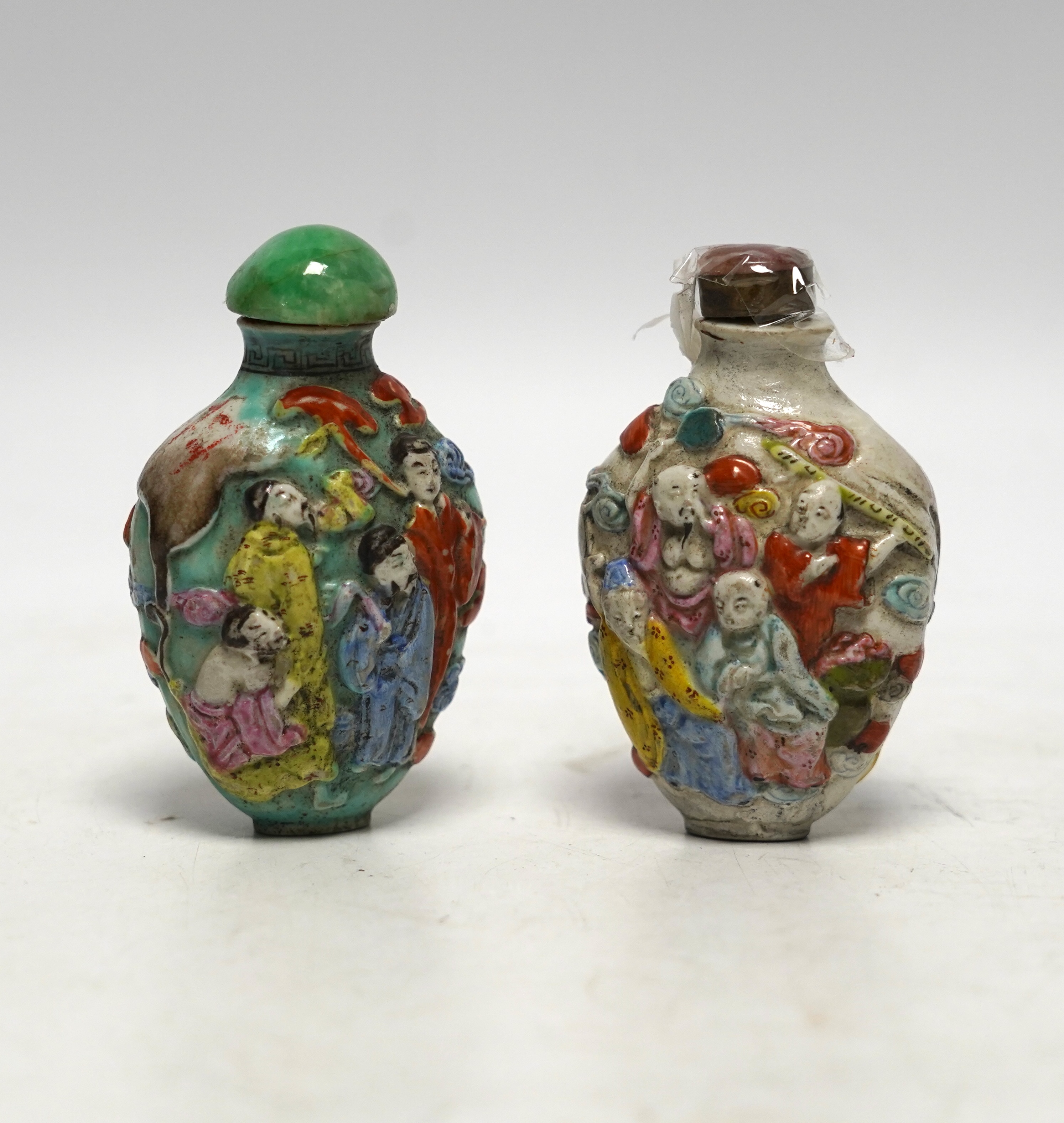 Two 19th century Chinese moulded and enamelled porcelain ’eight immortals’ snuff bottles, largest 8cm high
